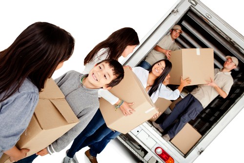 Local movers loading a van in Ealing on a residential street