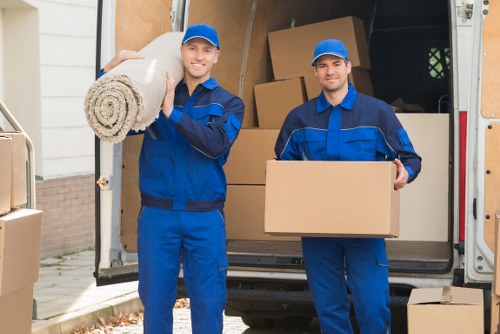 Team member using safe lifting practices during a house move