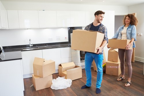 Packed moving boxes and furniture ready for a house relocation in Ealing