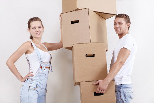 Removalists carrying household items through a London home entrance