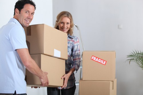 Packed moving boxes and furniture in a West London home