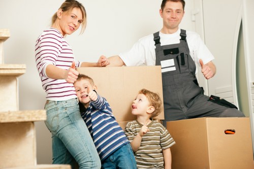 Removals crew handling boxes in a residential street
